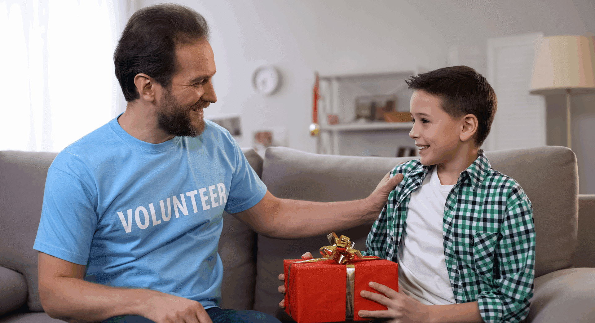 Happy child receiving red gift box