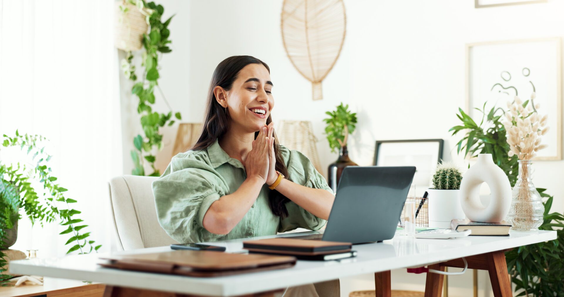 Woman smiling during video call at desk