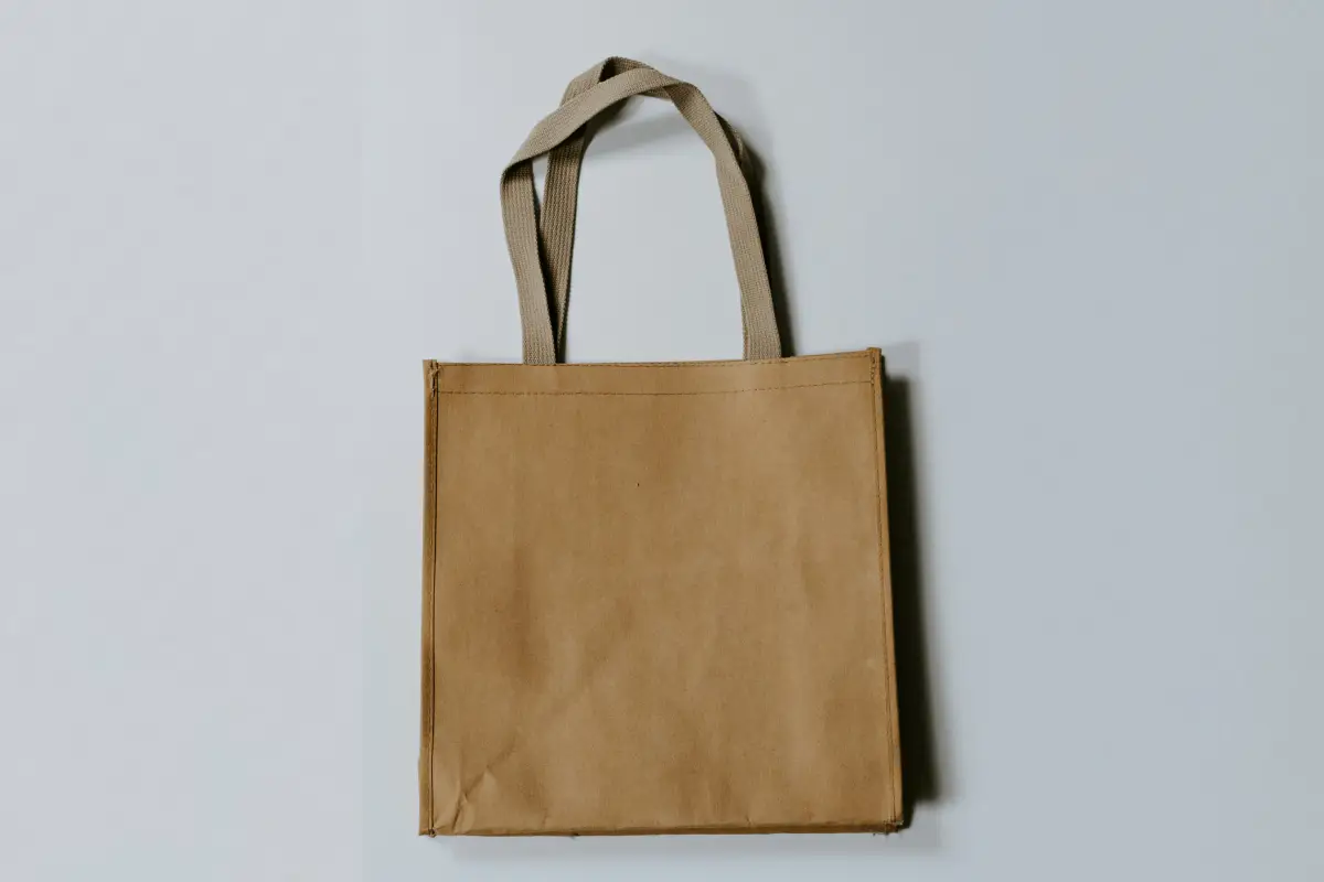 Brown reusable shopping bag on gray background.