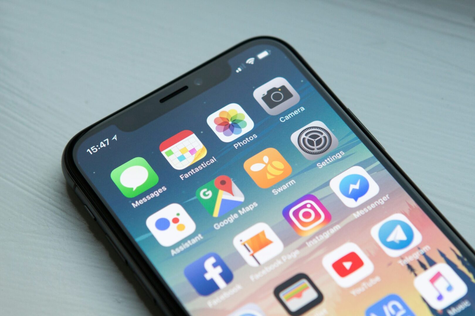 Smartphone displaying various app icons.