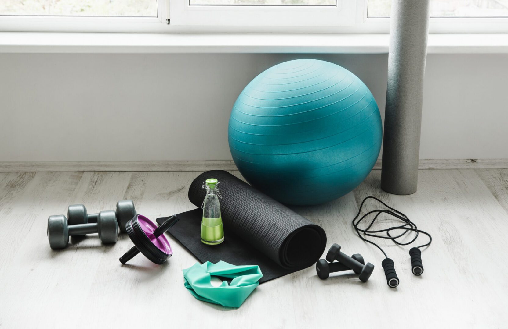 Home workout equipment on wooden floor.
