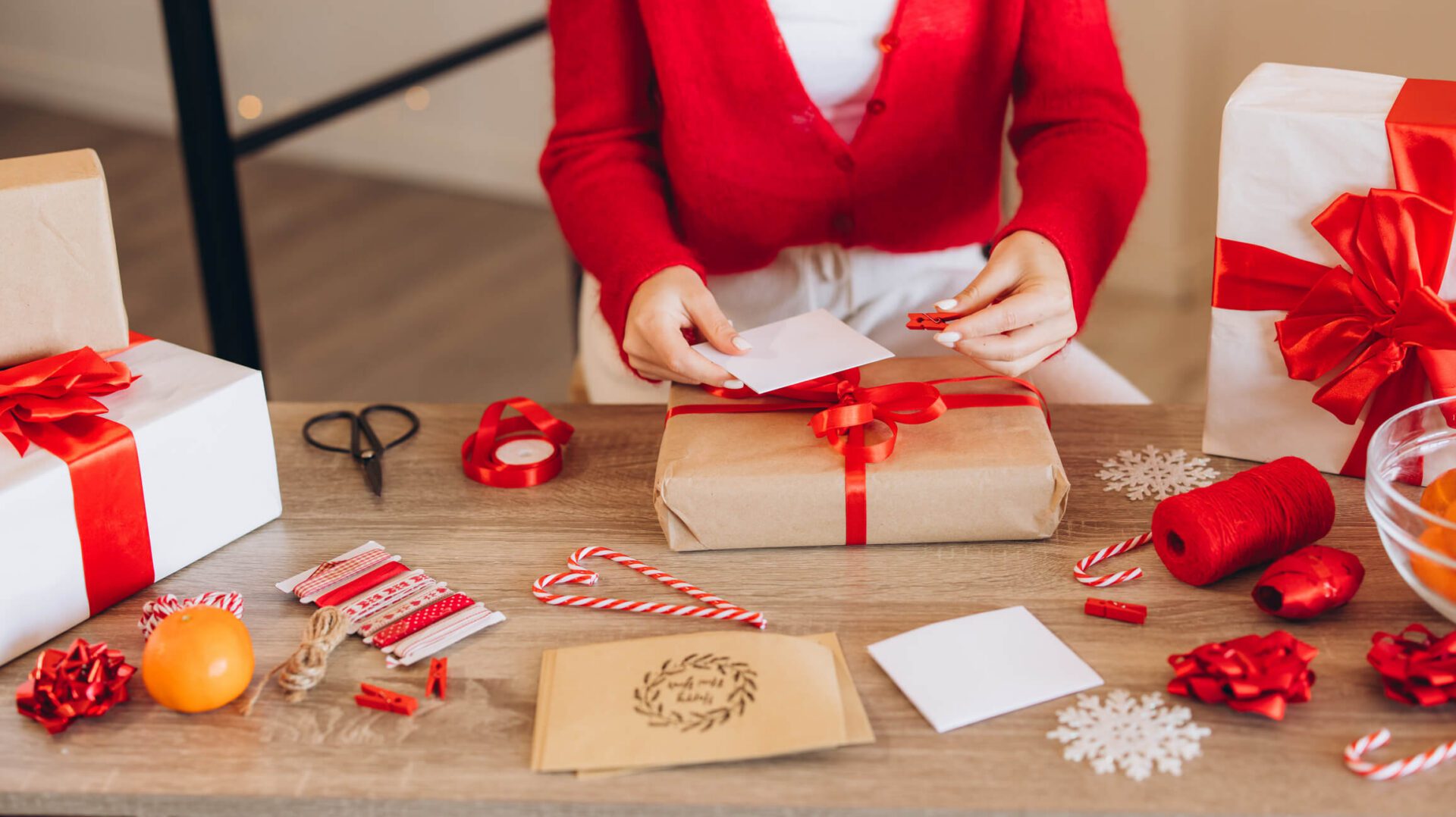 Gift wrapping with red ribbons and candy canes.